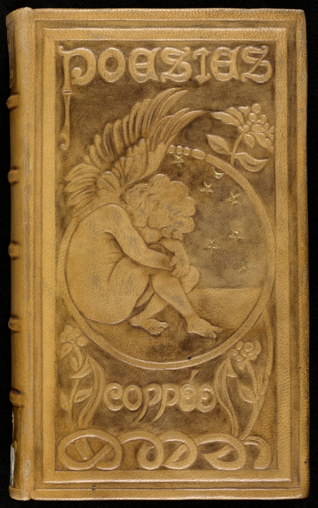 photo of a weathered leather book cover with a seated cherub depicted 